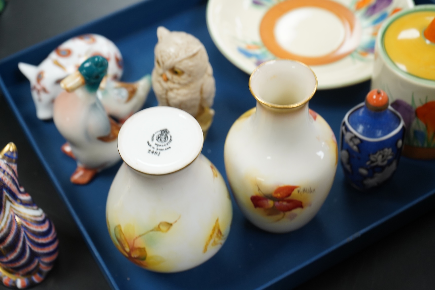 A collection of mixed porcelain and pottery to include four Worcester vases, one signed H. Blake, Clarice Cliff crocus pattern cup, saucer and sugar bowl and two Doulton Imari paperweights, largest 13cm high